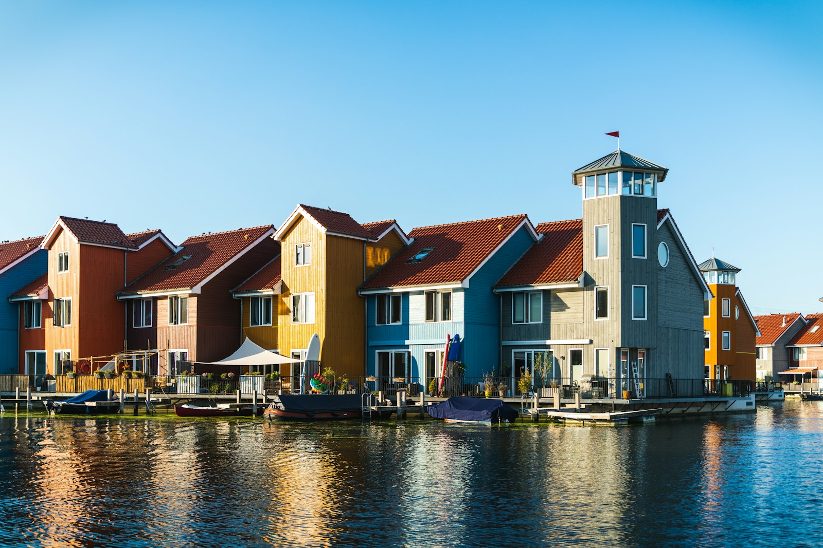 white and brown concrete building beside body of water during daytime