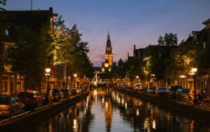 A canal with a clock tower in the background