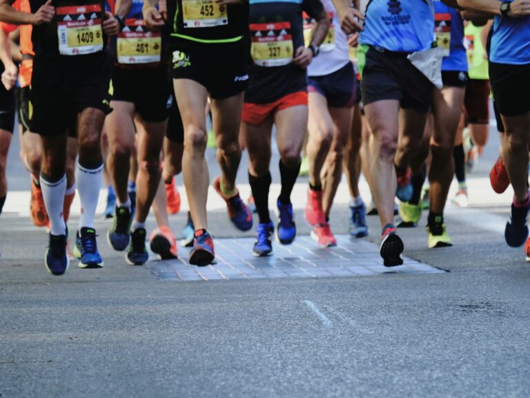 people running on gray asphalt road during daytime